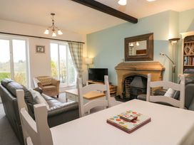 A living room with a fireplace and sofa at School Cottage Troutbeck Bridge near Windermere