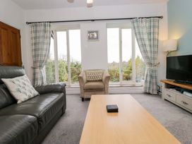 A living room with a sofa and a coffee table at School Cottage Troutbeck Bridge near Windermere