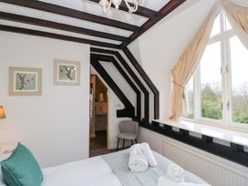 A bedroom with a bed and window at School Cottage in Troutbeck Bridge near Windermere