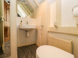 A bathroom with a sink, toilet and radiator at School Cottage in Troutbeck Bridge near Windermere