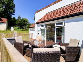 A patio area with seating and a table at Boo’s Bungalow in Callington near Gunnislake