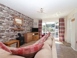 A living room with a sofa, television and coffee table at Boo’s Bungalow in Callington near Gunnislake