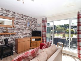A living room with a television and a sofa at Boo’s Bungalow in Callington near Gunnislake