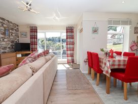 A living room with a sofa and dining set at Boo’s Bungalow near Gunnislake