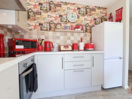 A kitchen with appliances and utensils at Boo’s Bungalow Callington near Gunnislake