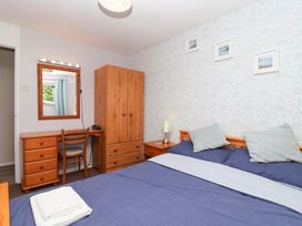 A bedroom with a bed and a desk at Boo’s Bungalow in Callington near Gunnislake