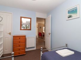 A bedroom with a bed and dresser at Boo’s Bungalow in Callington near Gunnislake