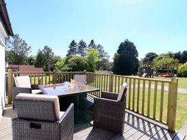 An outdoor seating area with a table and chairs at Boo’s Bungalow in Callington near Gunnislake
