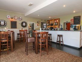 A bar area with high chairs and a counter at Boo’s Bungalow in Callington near Gunnislake