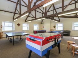 A game room with table tennis and foosball tables at Boo’s Bungalow in Callington near Gunnislake