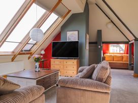A living room with a television and coffee table at Atelier in Bridlington