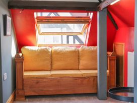 An attic with a sofa and a window at Atelier Bridlington