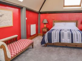 A bedroom with a bed a bedside table and a chaise longue at Atelier in Bridlington