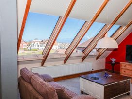A living room with a sofa and table at Atelier in Bridlington