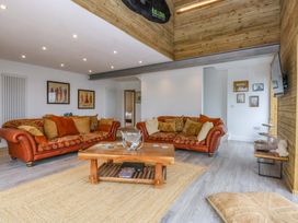 A living room with sofas and a coffee table at Gowan Brae in Criccieth