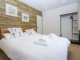 A bedroom with a bed and wardrobe at Gowan Brae in Criccieth