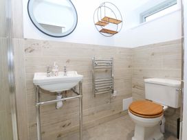 A bathroom with a sink and toilet at Gowan Brae in Criccieth
