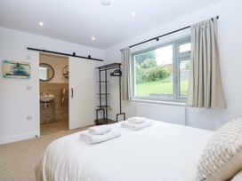 A bedroom with a bed and towels at Gowan Brae in Criccieth