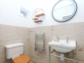 A bathroom with a toilet and a sink at Gowan Brae in Criccieth