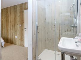 A bathroom featuring a shower and sink at Gowan Brae Criccieth