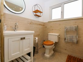 A bathroom with a sink and toilet at Gowan Brae in Criccieth