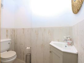 A bathroom with a toilet and sink at Gowan Brae in Criccieth
