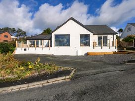 A house with large windows and a deck at Gowan Brae in Criccieth