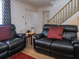 A living room with leather sofas and a table at Penrhos Walks in Holyhead