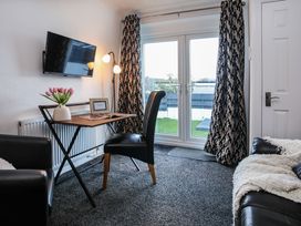 A living room with a desk and chair at Penrhos Walks in Holyhead