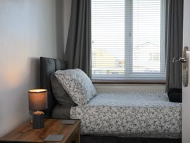 A bedroom with a bed and lamp at Penrhos Walks in Holyhead