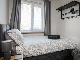 A bedroom with a bed and window at Penrhos Walks in Holyhead