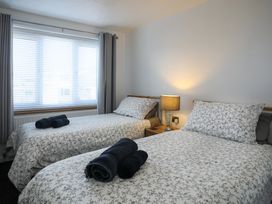 A bedroom with two beds and a lamp at Penrhos Walks in Holyhead