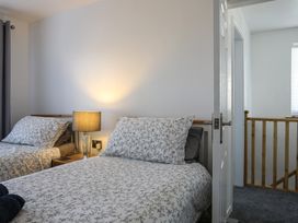 A bedroom with two beds and a lamp at Penrhos Walks in Holyhead