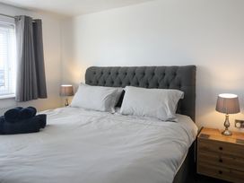 A bedroom with a bed and lamp at Penrhos Walks Holyhead