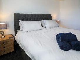 A bedroom with a bed and bedside table at Penrhos Walks Holyhead
