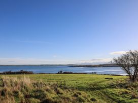 A scenic view of water and grassland at Penrhos Walks Holyhead