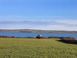 A view of water and grass fields at Penrhos Walks Holyhead