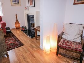 A living room with a fireplace and seating at Burna in Letterkenny