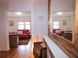 A living room with a sofa, armchair and artwork at Burna in Letterkenny