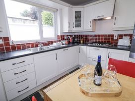 A kitchen with a sink and wine glasses on a table at Burna in Letterkenny