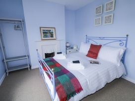 A bedroom with a bed and side table at Burna in Letterkenny