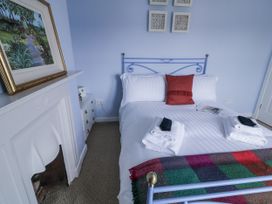 A bedroom with a bed and towels arranged at Burna in Letterkenny