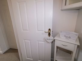 A bathroom door with a sign and a cabinet at Burna in Letterkenny