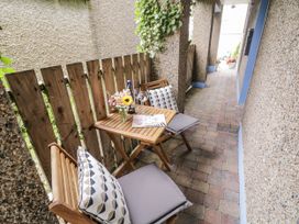 An outdoor patio with a table and chairs at Burna in Letterkenny