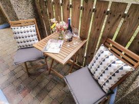 A seating area with a table and flowers at Burna in Letterkenny