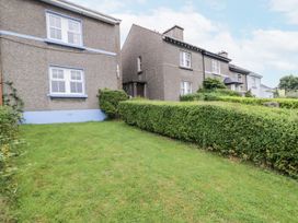 An outdoor view of houses with a hedge and grass at Burna in Letterkenny