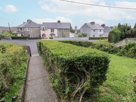 An outdoor view with houses and a hedge at Burna in Letterkenny