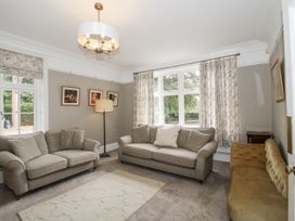 A living room with sofas and a lamp at The Old Vicarage Kimbolton near Leominster