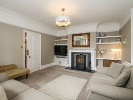 A living room with a fireplace and comfortable seating at The Old Vicarage in Kimbolton near Leominster