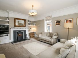 A living room with a sofa and fireplace at The Old Vicarage in Kimbolton near Leominster
